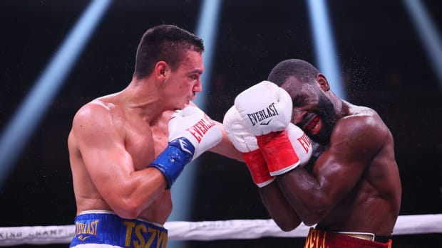       Tim Tszyu (white with blue trunks) v Terrell Gausha (white with red and gold trunks) box in the Super Welterweight main event at the Armory in 2022 in Minneapolis, United States. Tszyu, will be defending his title against Mendoza this coming weekend. ADAM BETTCHER/GETTY IMAGES. 